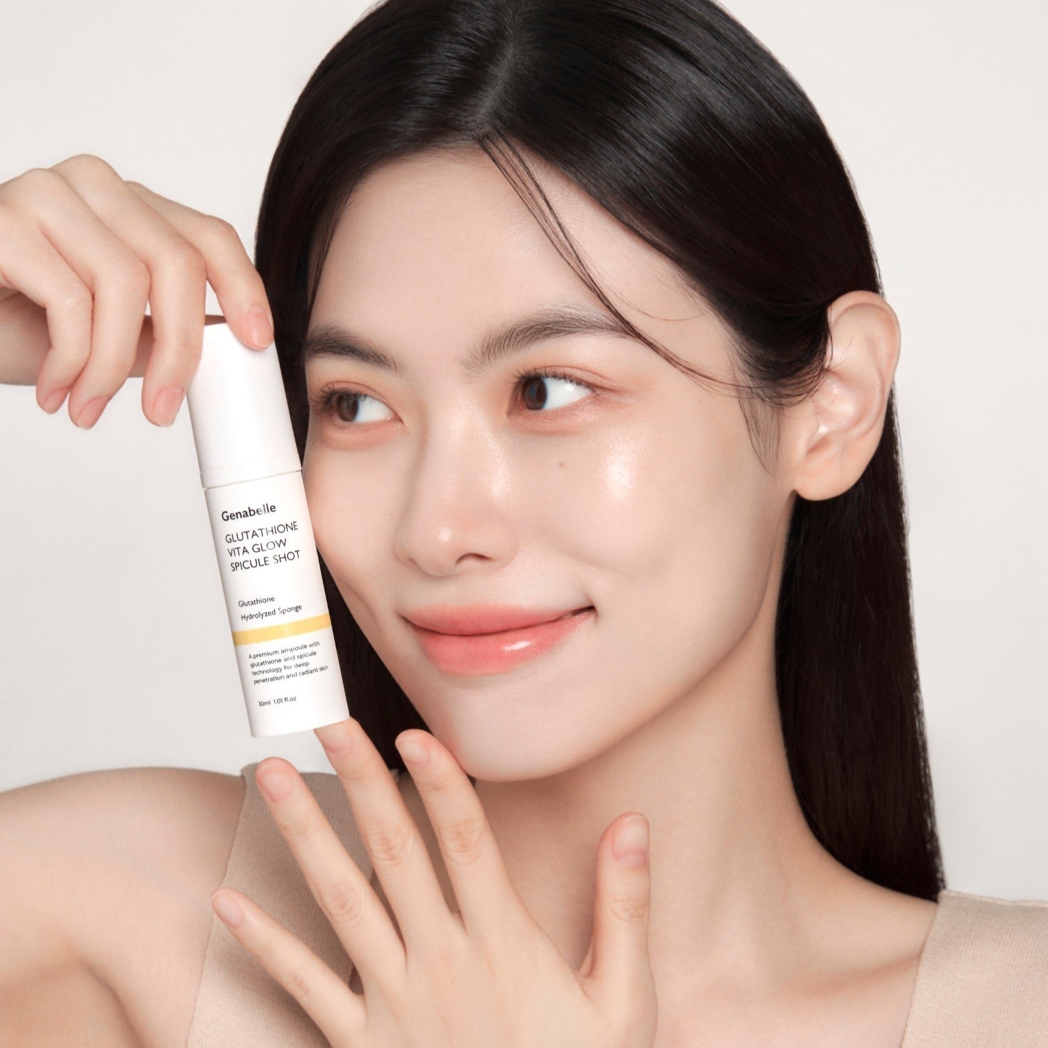 Woman holding GENABELLE Glutathione Vita Glow Spicule Shot 30ml skincare product, highlighting glowing skin and product bottle.
