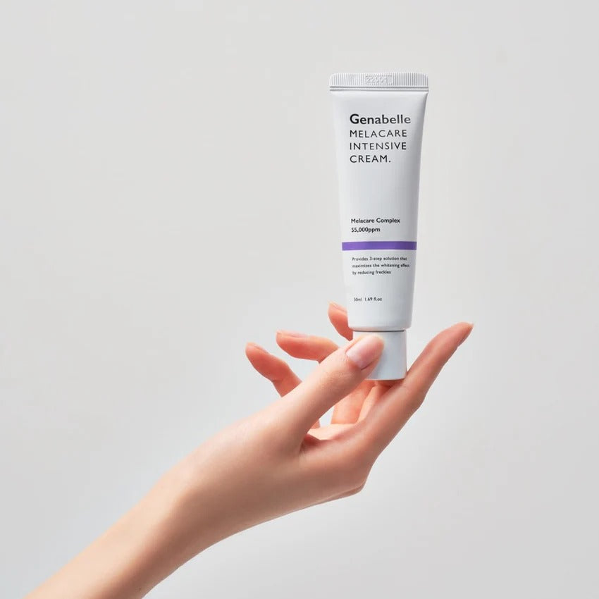 Hand holding GENABELLE Melacare Intensive Cream 50ml product tube against neutral background.