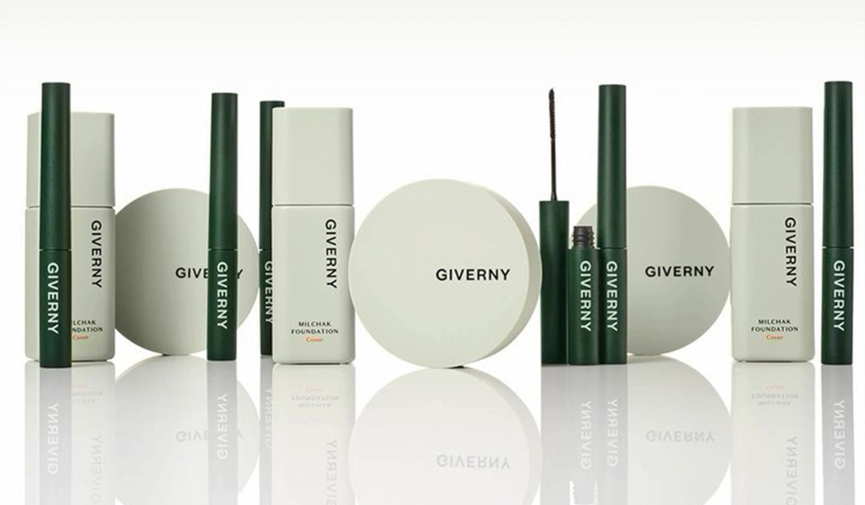 Giverny makeup product line including foundation, eyeliner, and compact on a reflective surface.