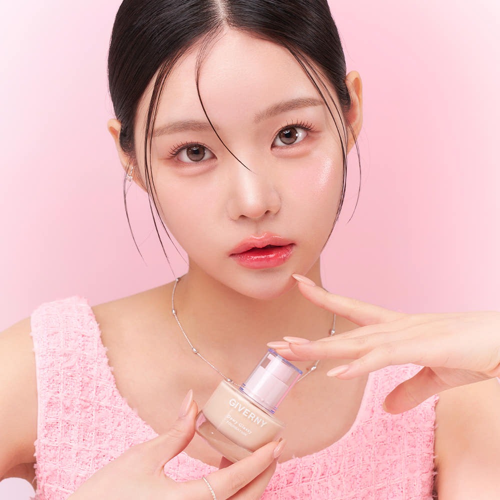 Model holding GIVERNY Dewy Glassy Foundation 30ml (SPF38, PA++), showcasing the product's elegant packaging and dewy finish.