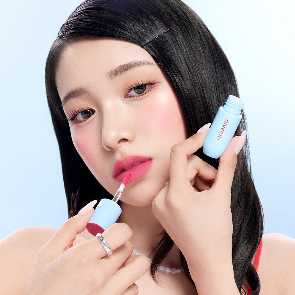 Woman applying GIVERNY Fluffy Sheer Tint 3.5g lip tint.
