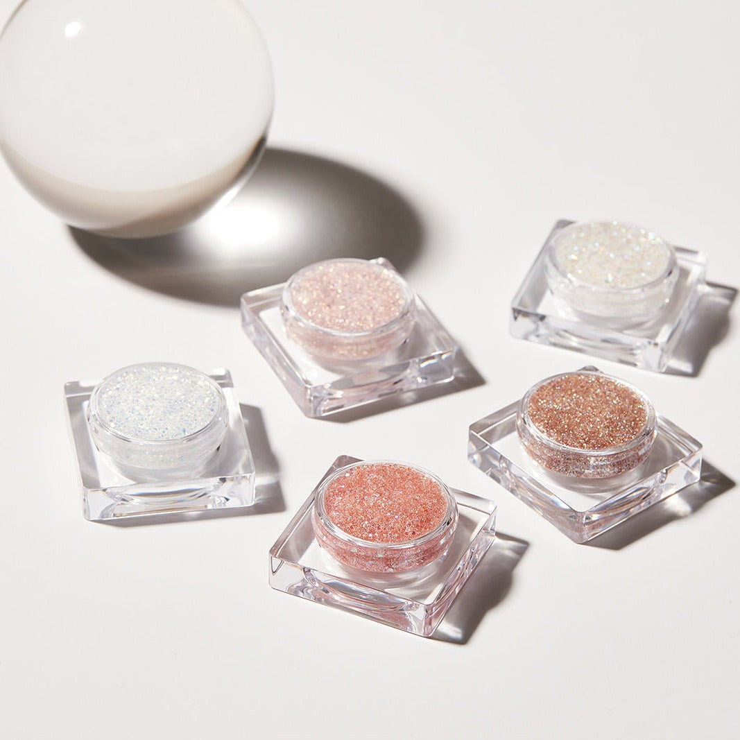 Five containers of GLINT Glitter Gel in various colors with light reflection.