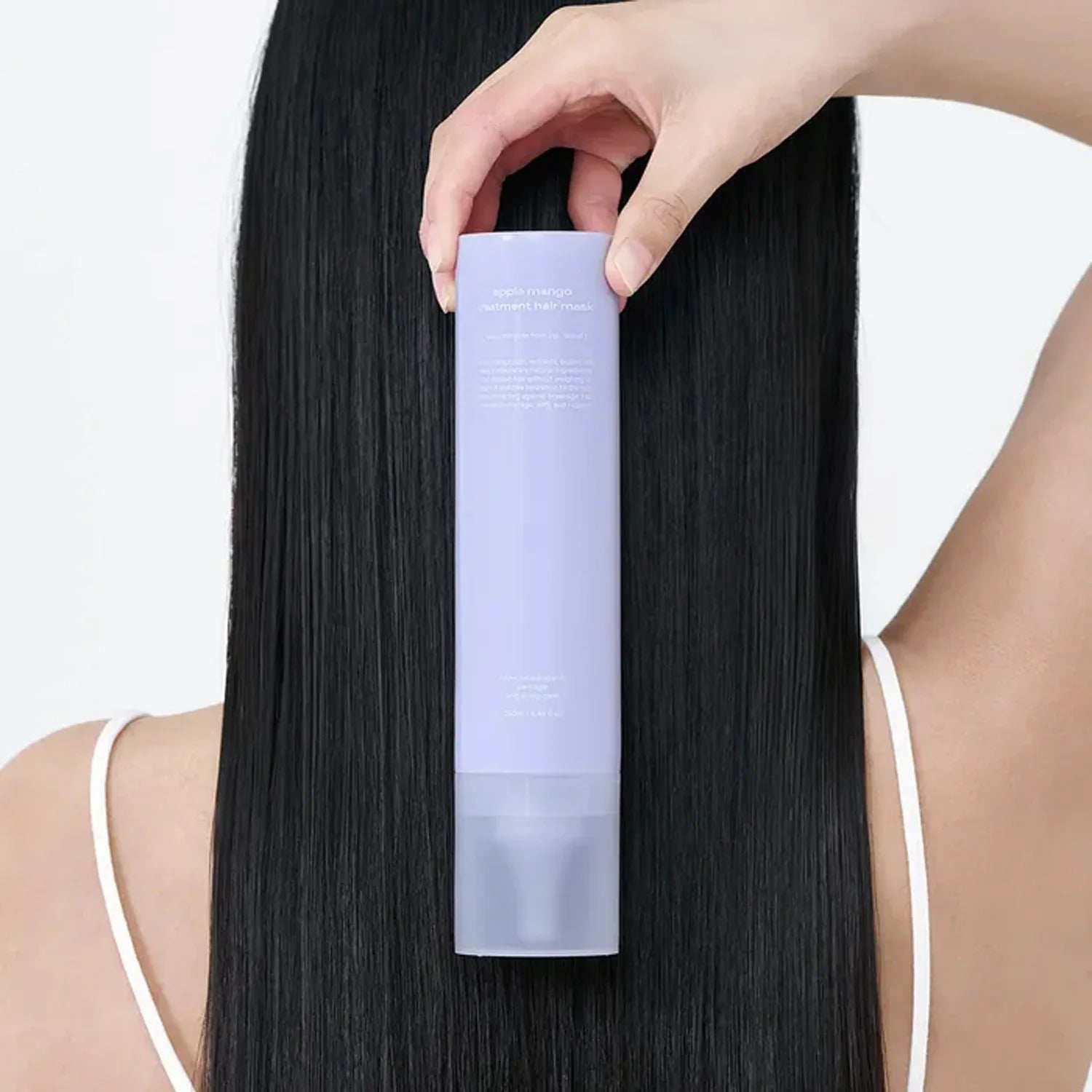 GLOW Apple Mango Hair Treatment 250ml being applied on long black hair