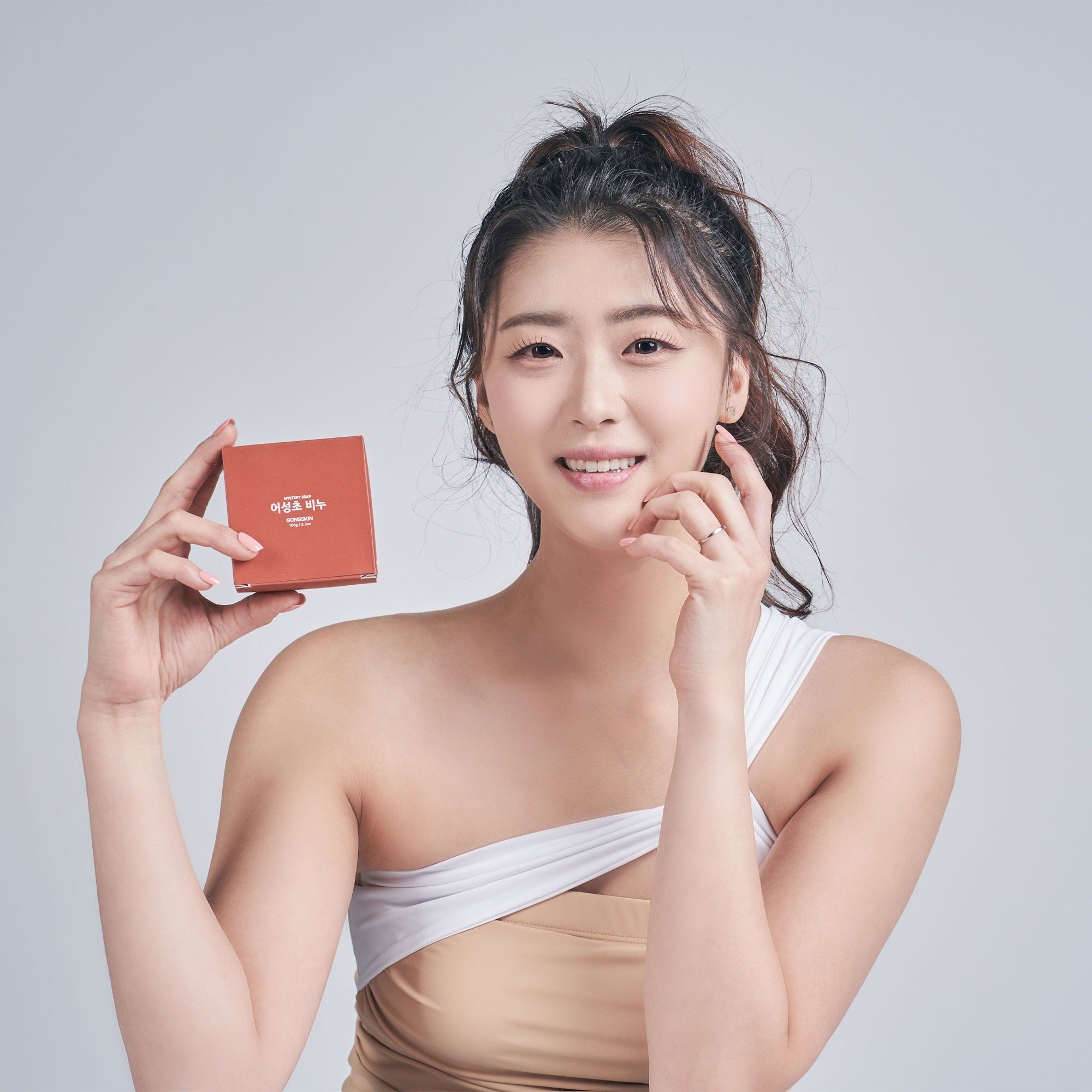 Person holding GONGSKIN Eoseongcho Soap 100g box, showcasing the product.