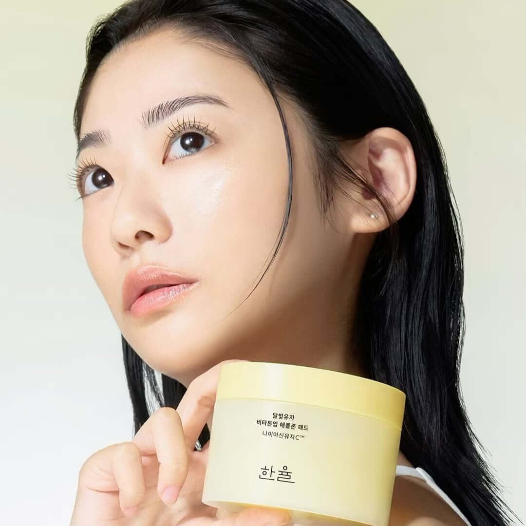 Woman holding HANYUL Moonlight Yuja Vita Tone Up Apple Zone Pad