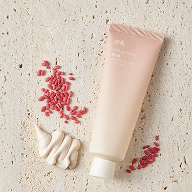 HANYUL Nature in Life Hand Cream 50ml on textured surface with cream and seeds
