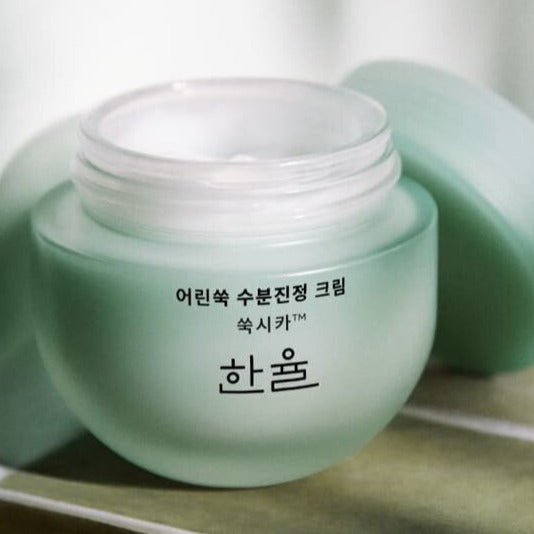 HANYUL Pure Artemisia Calming Water Cream 55ml in an open jar, showcasing cream texture and elegant green packaging.