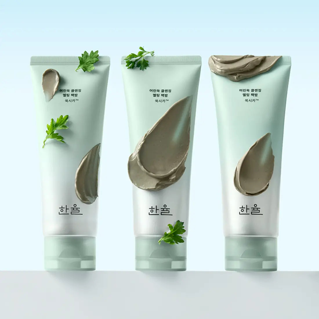 Three tubes of HANYUL Young Artemisia Cleansing Pack Balm 100g with green herbal accents on packaging, displayed on a light background.