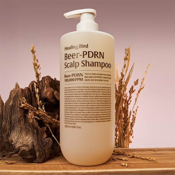 HEALING BIRD Beer PDRN Anti-Hair Loss Shampoo 1000ml bottle against a natural backdrop, promoting hair care and strength.