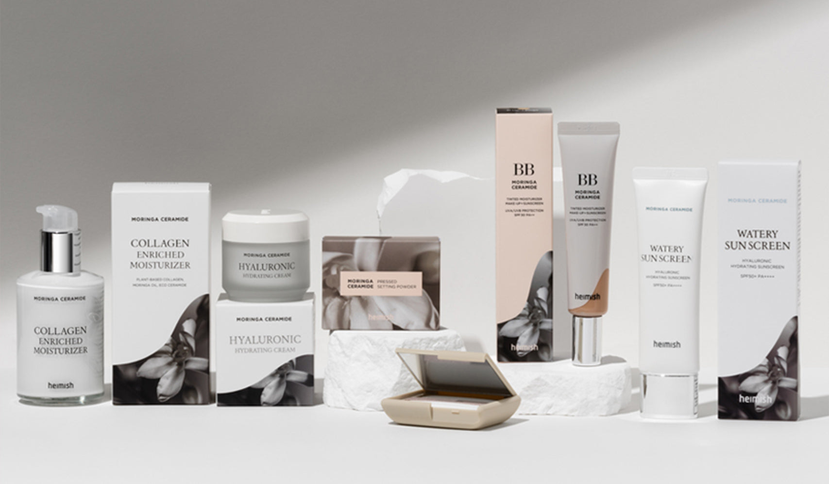 Heimish skincare products including moisturizers, BB cream, and sunscreen arranged on a white surface.