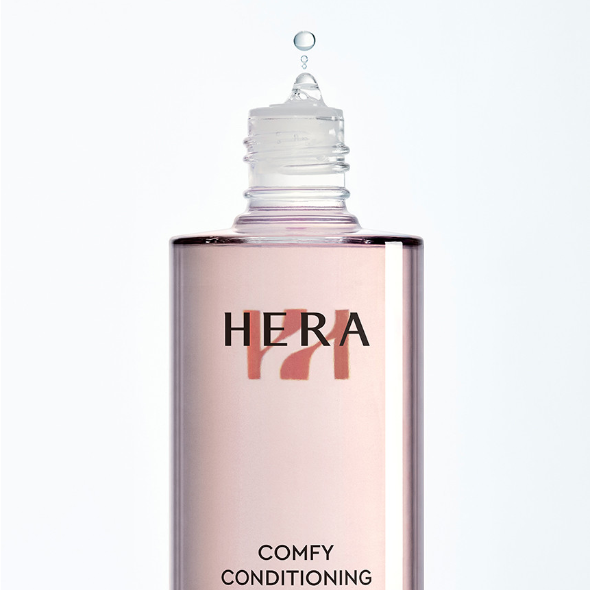HERA Comfy Conditioning Essence 150g bottle with droplet