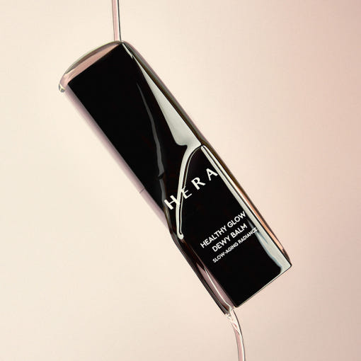 HERA Healthy Glow Dewy Balm 10g product image showcasing sleek black packaging and elegant design.