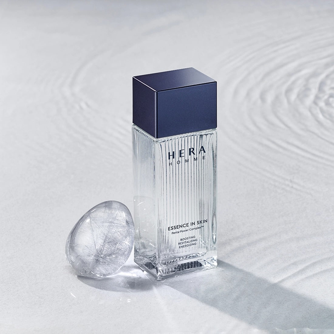 HERA Homme Essence In Skin 125ml bottle product shot by Gentleman Korea for men’s skincare, clear textured glass with navy cap