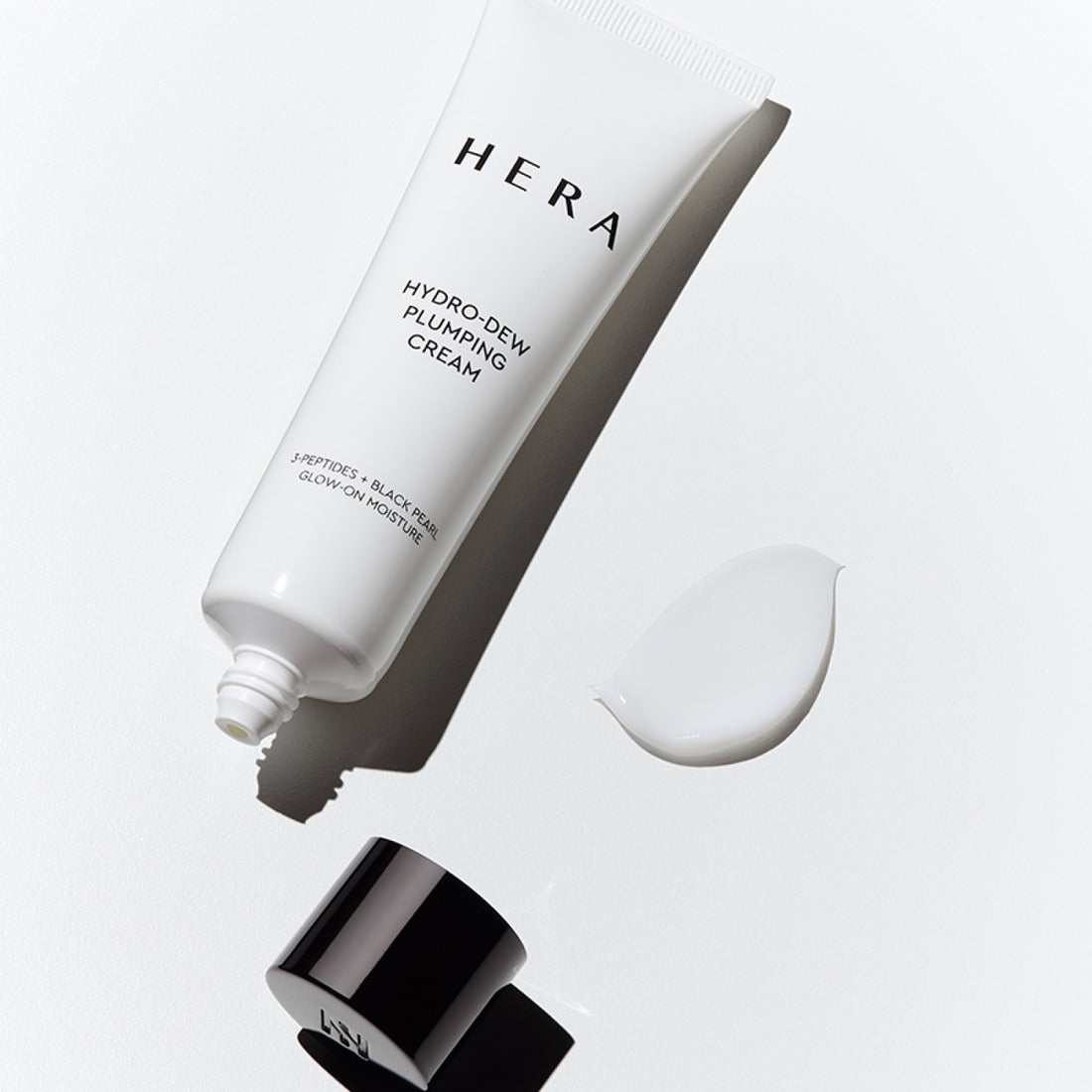 HERA Hydro-Dew Plumping Cream 50ml tube with cap and cream swatch on a white background.
