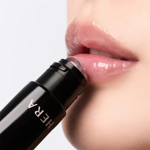 Woman applying HERA Lip Serum Intense 11g for hydrated lips