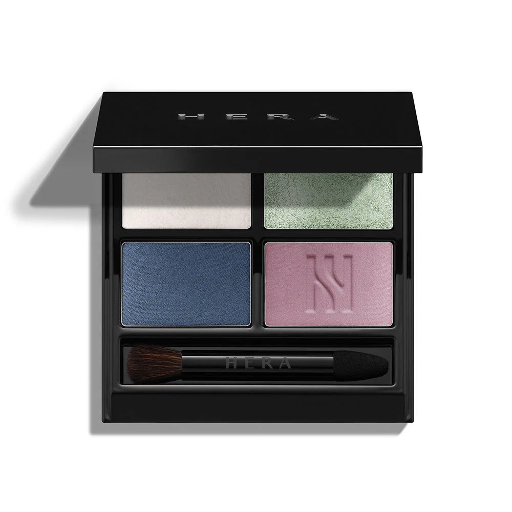 HERA Quad Eye Color palette with four vibrant shades and an applicator brush in a sleek black case.