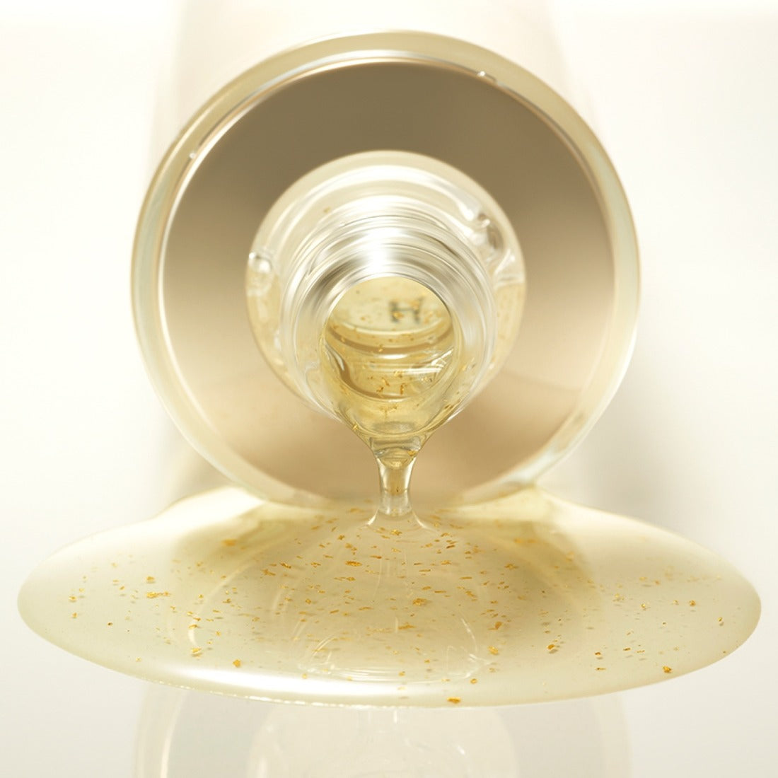 HERA Signa Skin refreshing Water 180ml pouring from bottle, showcasing its hydrating formula with visible particles on a light background.