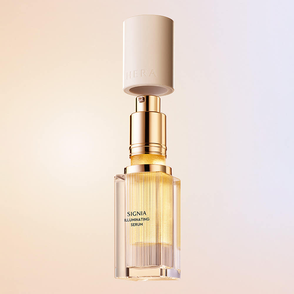 HERA Signia Illuminating Serum 30ml bottle with golden detailing, featuring luxury skincare packaging.