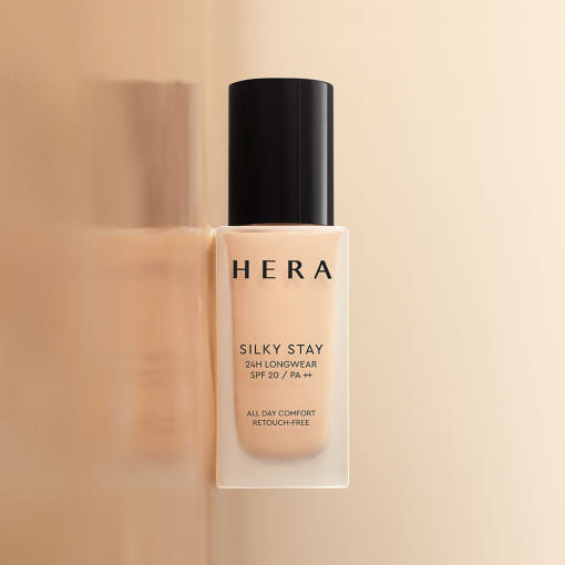 HERA Silky Stay 24h Longwear Foundation 30g bottle on a beige background.