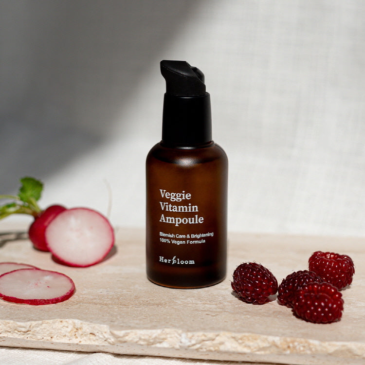 HERBLOOM Veggie Vitamin Ampoule 30ml with raspberries and radish slices on a stone surface