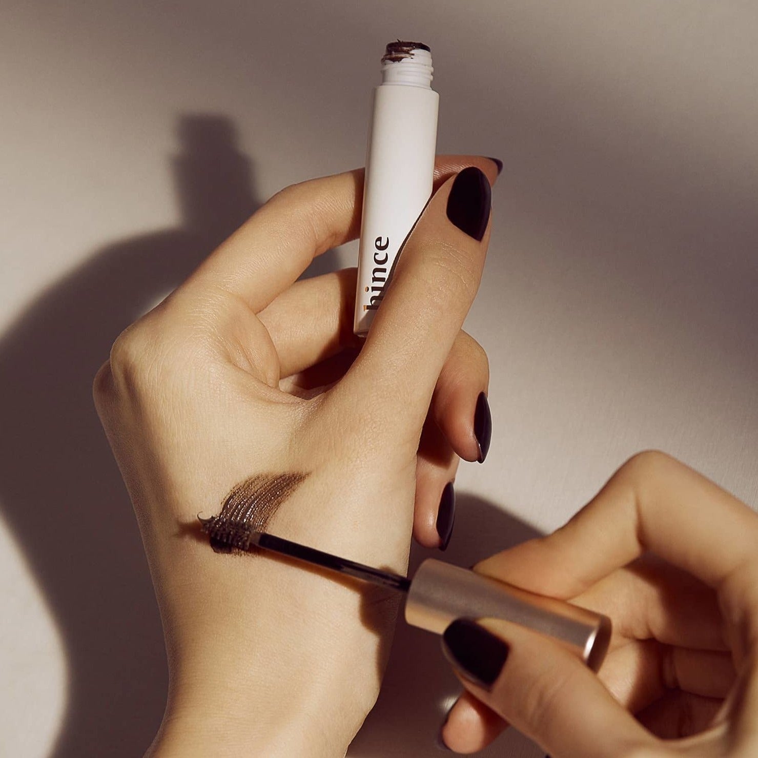 Applying HINCE Signature Brow Shaper with brush for styling