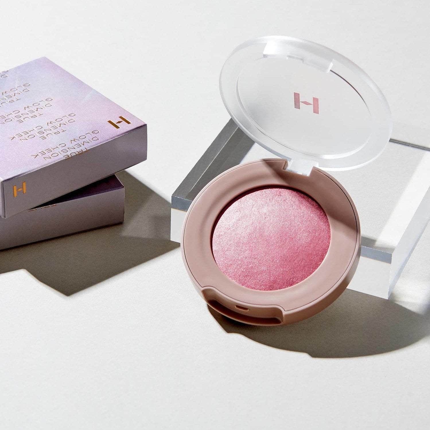 HINCE True Dimension Glow Cheek in pink shade with packaging, highlighting its luminous texture for a radiant look.