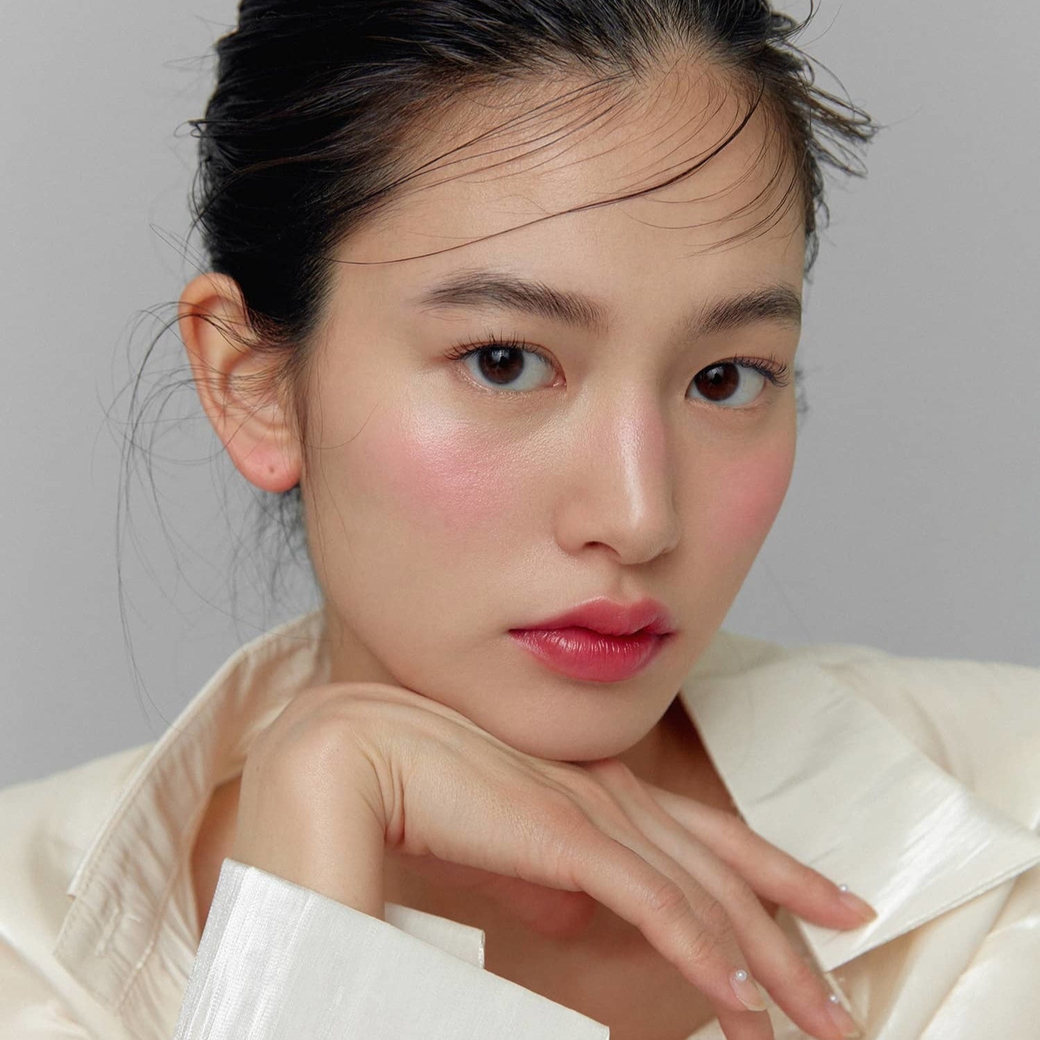 Model wearing HINCE True Dimension Glow Cheek showcasing a natural blush look.