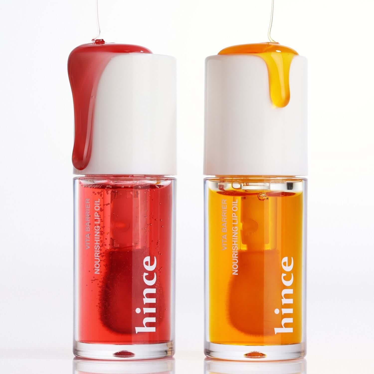 HINCE Vita Barrier Nourishing Lip Oil in red and orange, showing two bottles with oil dripping from the top.