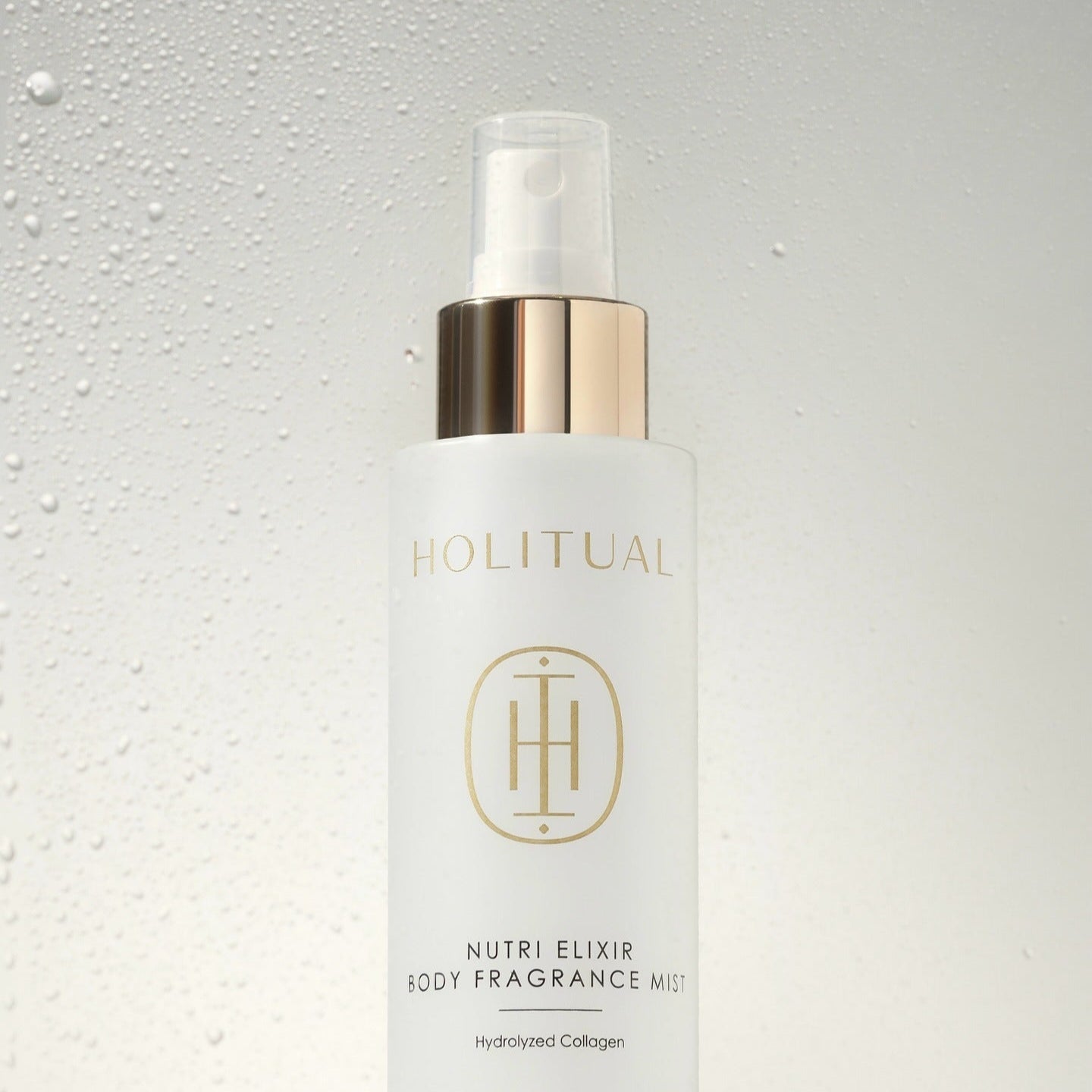 HOLITUAL Nutri Elixir Body Fragrance Mist 100ml bottle with elegant design against water droplet background