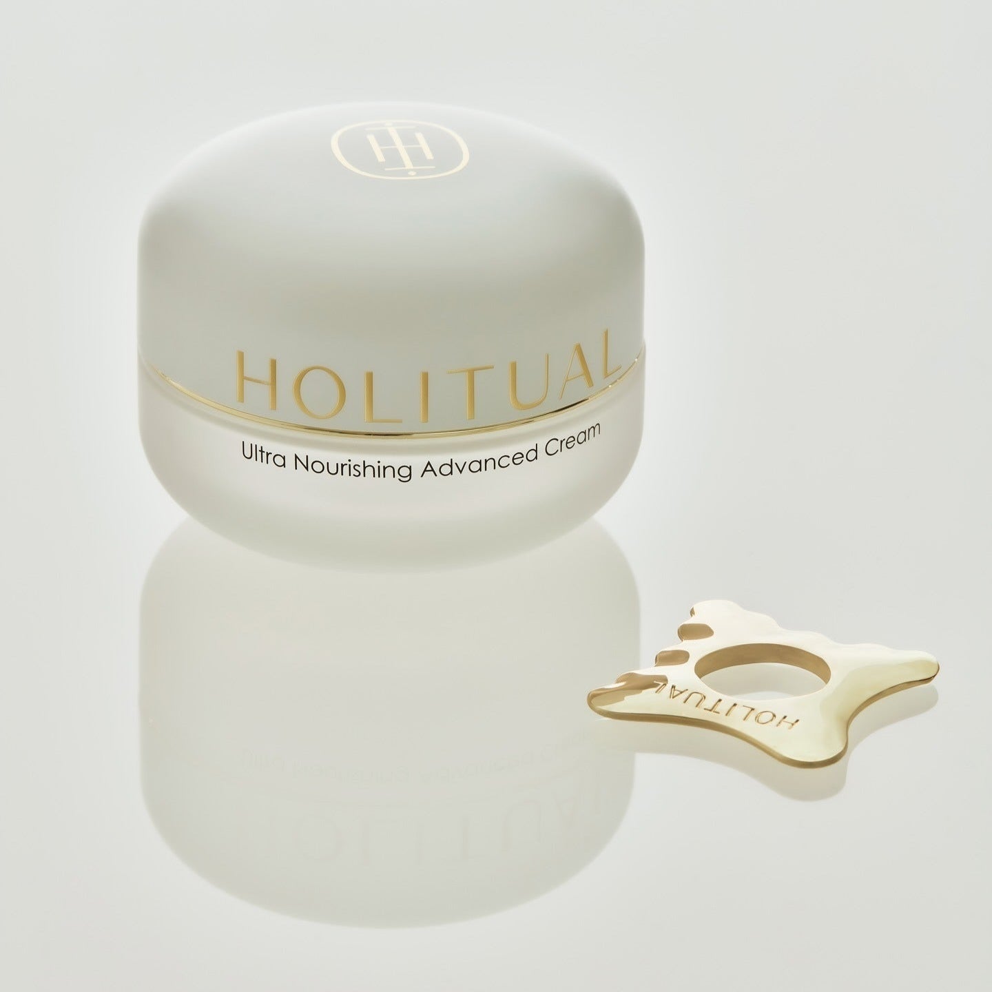 HOLITUAL Ultra Nourishing Advanced Cream with gold accessory on white background