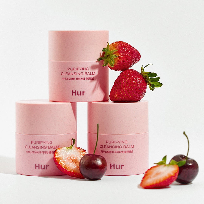 HOUSE OF HUR Purifying Cleansing Balm with fresh strawberries and cherries, skincare product in pink packaging.