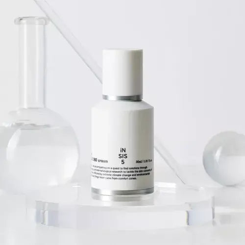 HUXLEY Biosys 360 Cream bottle on a glass surface with laboratory glassware in the background.