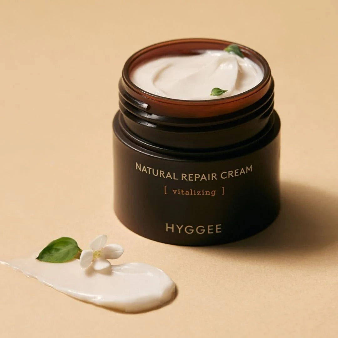 HYGGEE Nature Repair Cream 50ml jar with cream texture and plant elements on beige background.