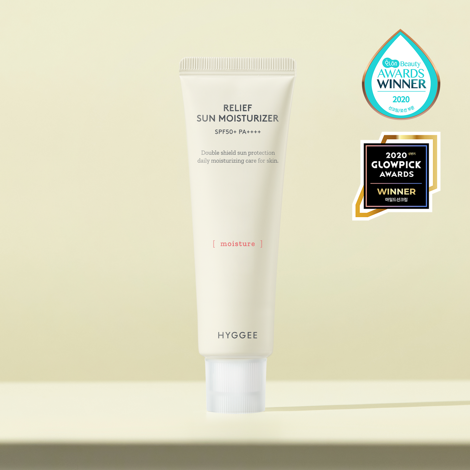 HYGGEE Relief Sun Moisturizer SPF50+ 50ml tube with award labels for daily sun protection and moisture.