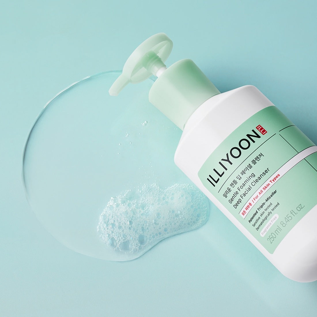 Bottle of ILLIYOON Gentle Deep Facial Cleanser 250ml with foamy texture on a mint background