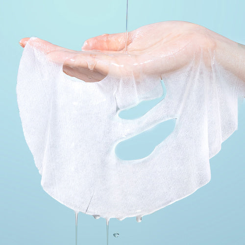 ILSO Peptide Pore Tension Mask 1 Sheets being held by a hand with water pouring over it