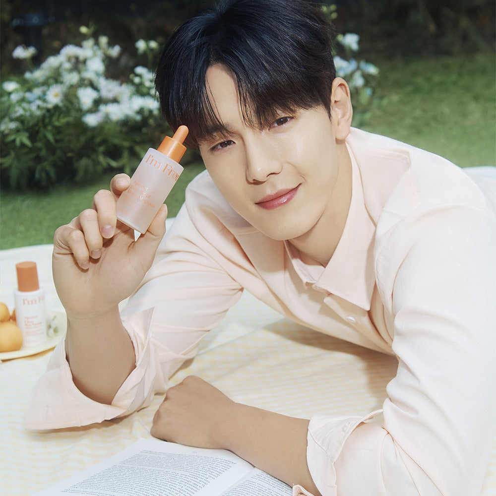 Man holding I'M FROM Apricot Dark Spot Drop Ampoule 50ml outdoors