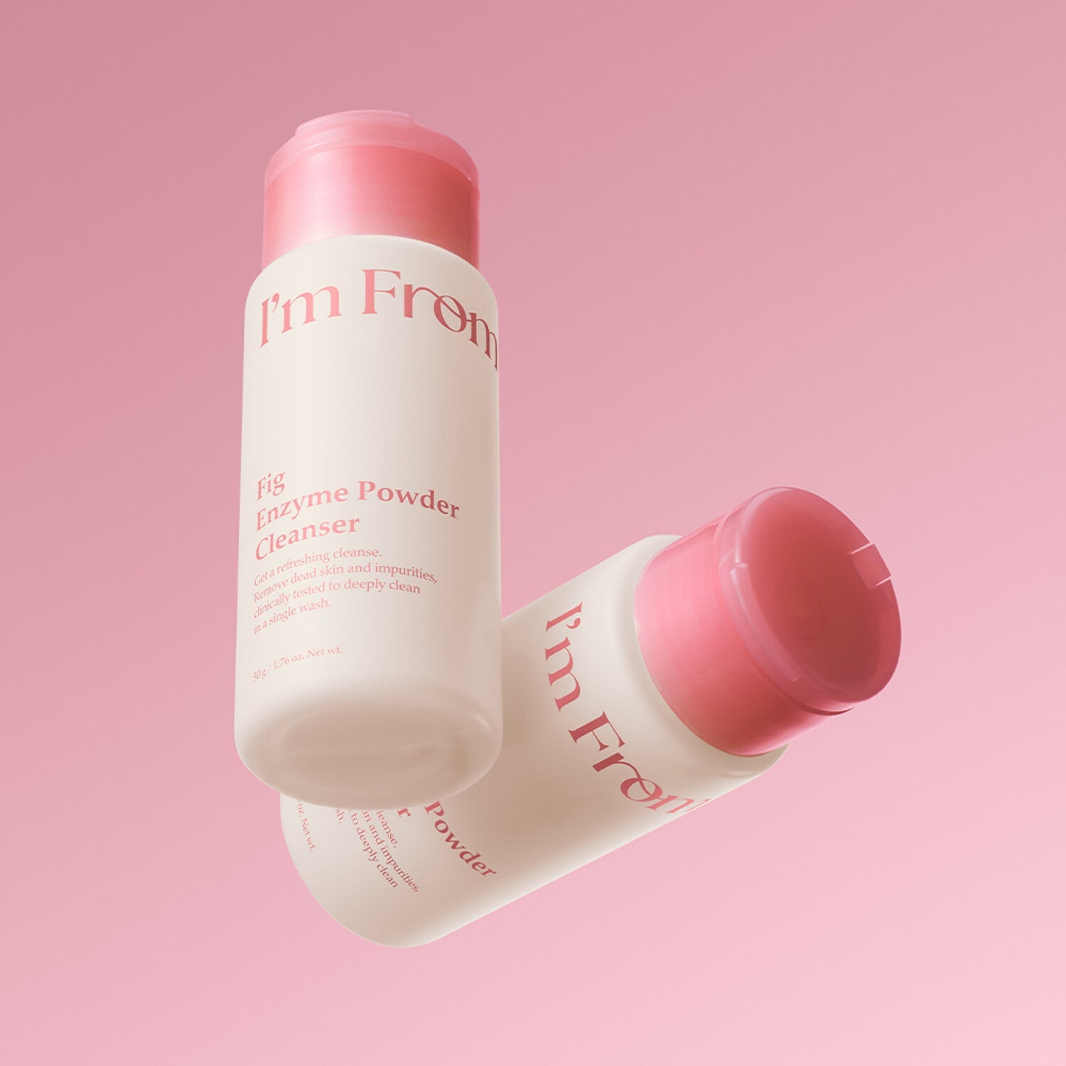 I'M FROM Fig Enzyme Powder Cleanser 50g on a pink background, featuring two bottles, enhancing skin clarity with natural fig enzymes.