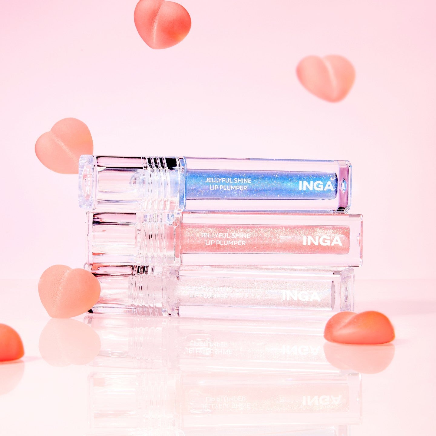 INGA Jellyful Shine Lip Plumper products with pink and blue shades on a pink background.