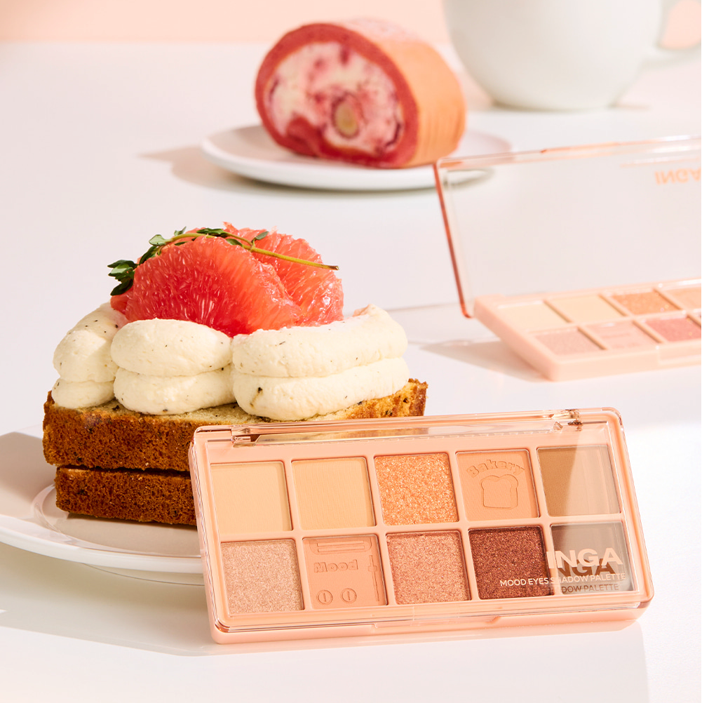 INGA Mood Eyes Shadow Palette featuring nude and peach eyeshadow shades, displayed in a creative dessert-themed setting with cake.