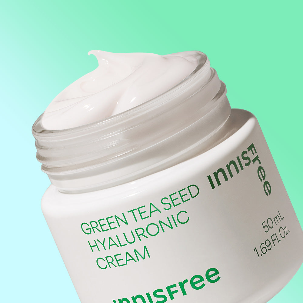 Open jar of INNISFREE Green Tea Seed Hyaluronic Cream 50ml with product label visible.