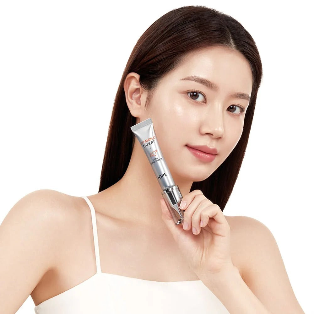 IOPE Vitamin C Expert 40% Mask Concentrate 15g held by woman