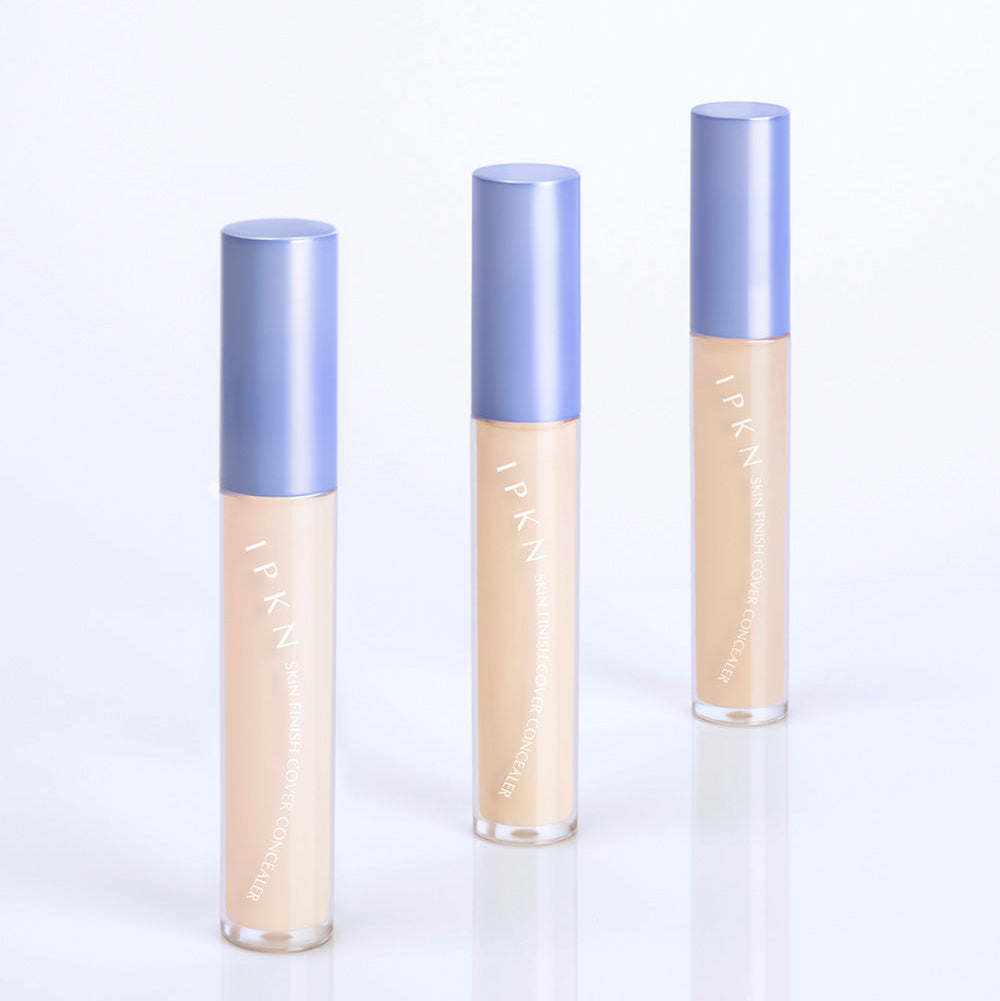 Three bottles of IPKN Skin Finish Cover Concealer SPF30 PA++ with blue caps on a white background.