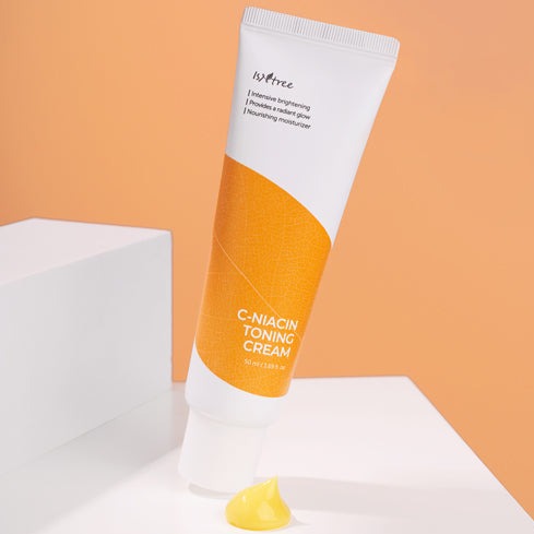 ISNTREE C-Niacin Toning Cream 50ml on display with orange background