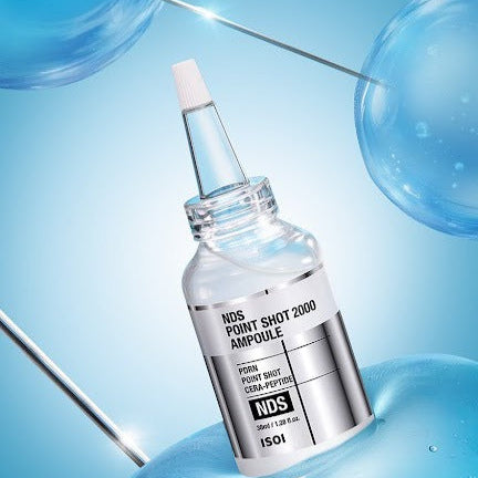 ISOI NDS Point Shot 2000 Ampoule 38ml in a sleek glass bottle with blue bubbles in the background.
