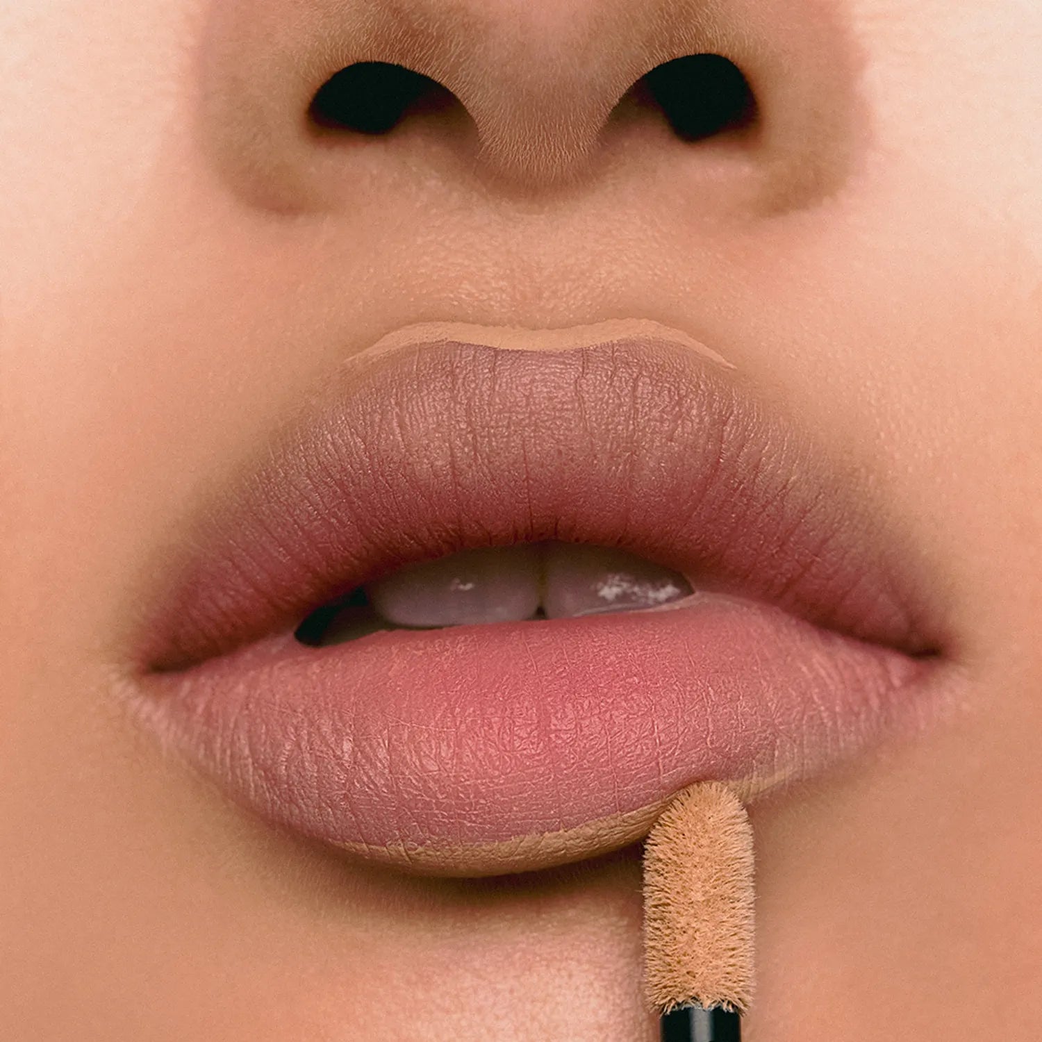 Close-up of lips applying JAVIN DE SEOUL Wink Lip Shade Primer for a smooth finish.