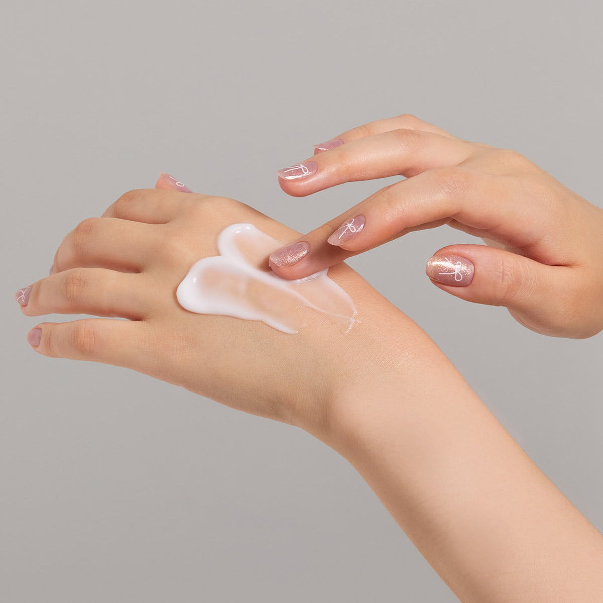 Applying JULYME Perfume Shea Butter Hand Cream 30ml on hands for smooth and moisturized skin.
