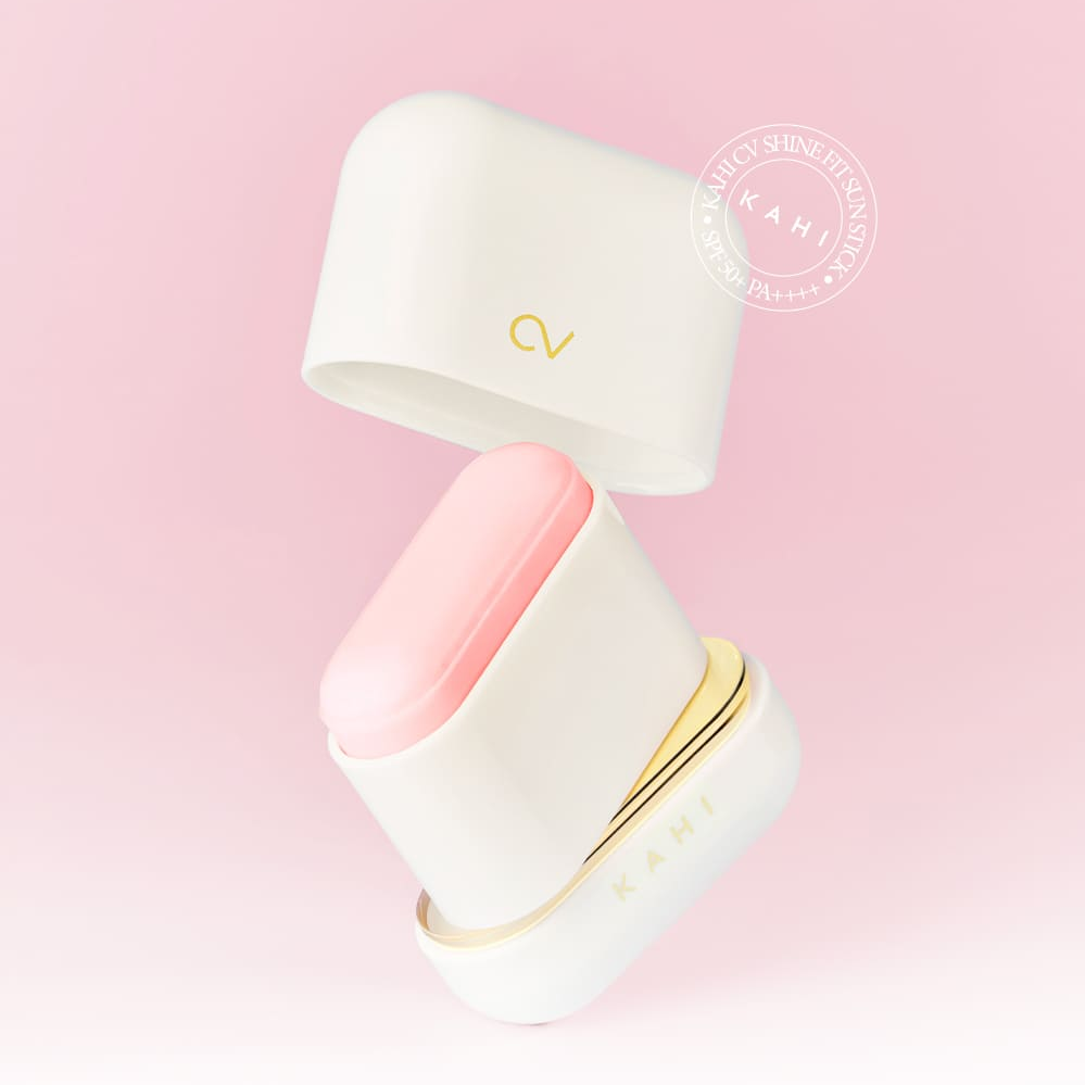 KAHI CV Shine Fit Sun Stick (13.5g) in open case against a pink background, showing the sun stick's packaging and design.