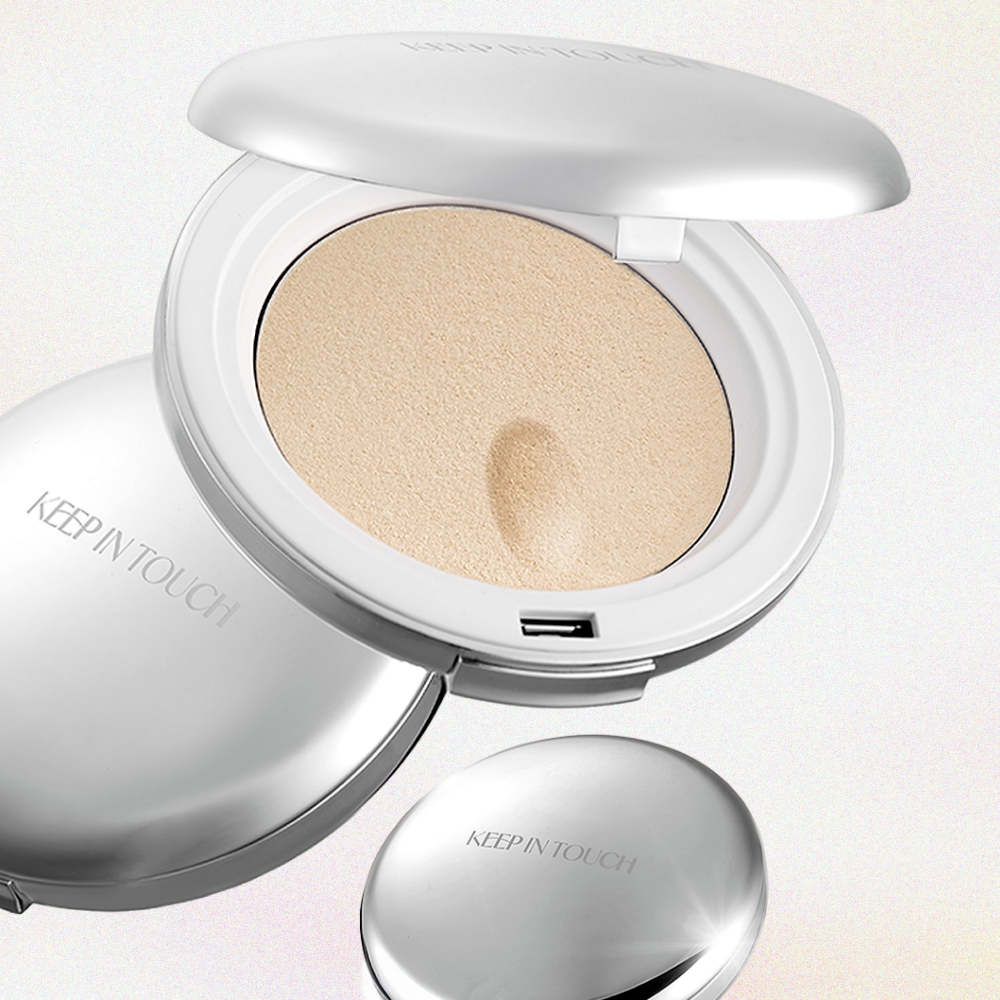 KEEP IN TOUCH Sot Cloud Blur Powder Pact in sleek silver compact case, open to show finely milled powder for a smooth finish. 