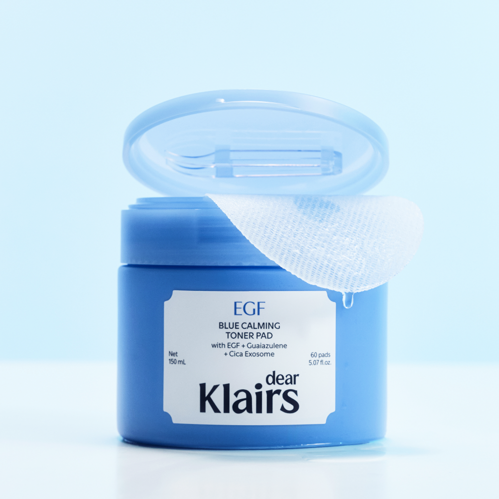 KLAIRS EGF Blue Calming Toner Pads 60 Pads jar with open lid, showcasing toner pad texture and product details on a light blue background.